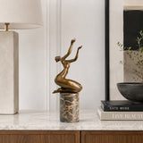 Seated Female Dancer Bronze Sculpture displayed in a modern interior