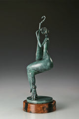 Opposite side view of the seated female pipa player sculpture on a circular wooden base