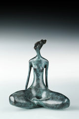 Abstract female yoga statue seated cross-legged 