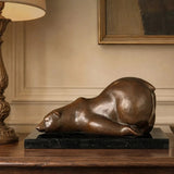 Sleeping polar bear bronze sculpture displayed in a warm modern interior