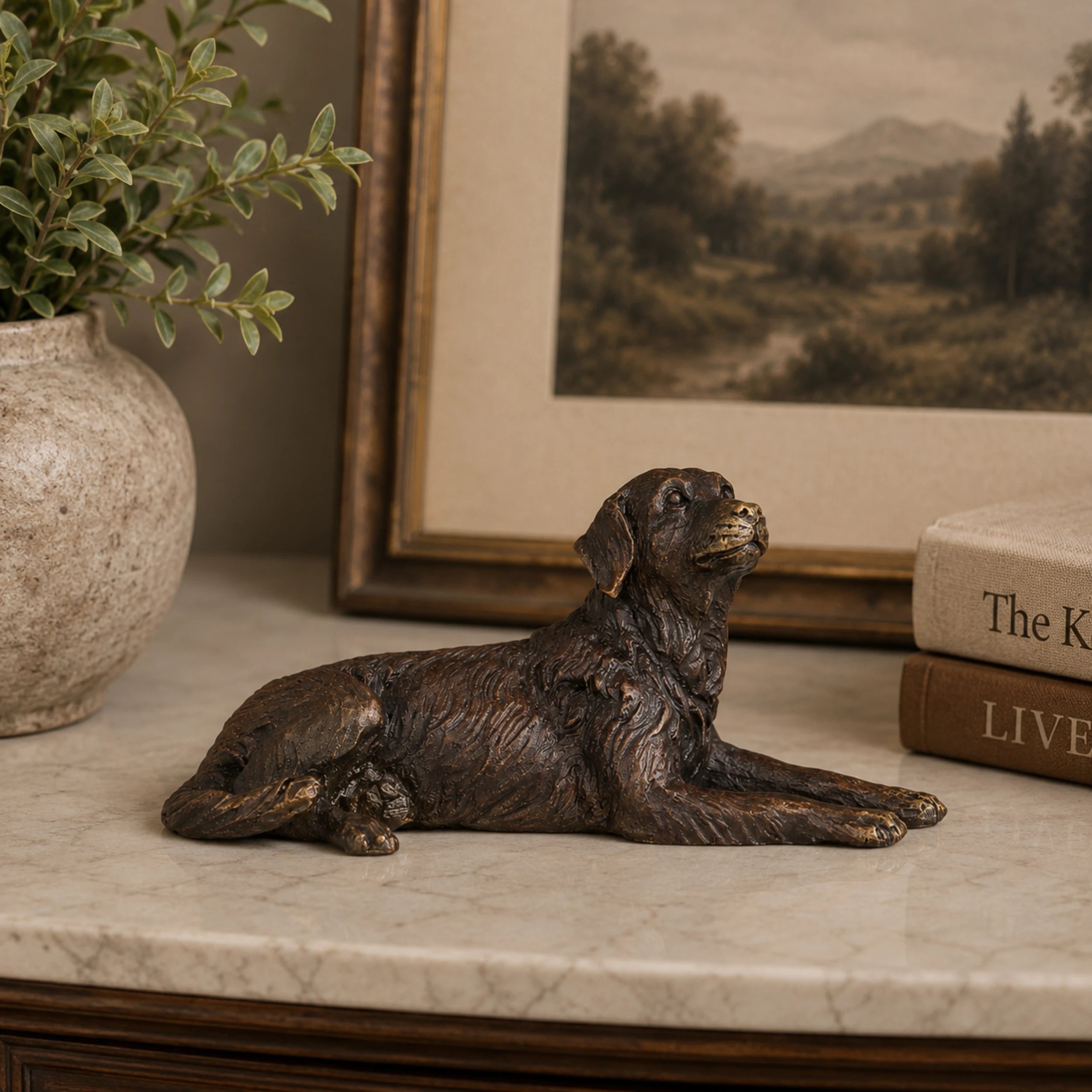 Small bronze lying dog sculpture displayed as charming desk, shelf, and home decor