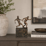 Soccer Players Duel Bronze Sculpture displayed in a modern interior