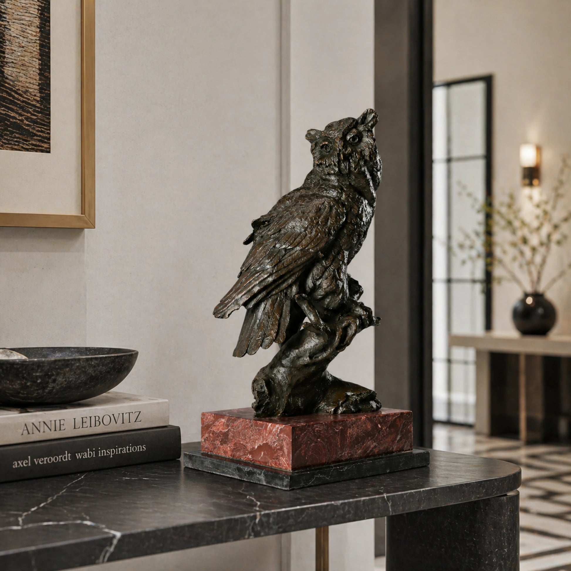 a realistic bronze owl sculpture with detailed feather textures and a striking red and black marble base. A symbol of wisdom, perfect for home, office, or library decor.