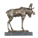 Standing moose bronze sculpture displayed in a rustic lodge interior