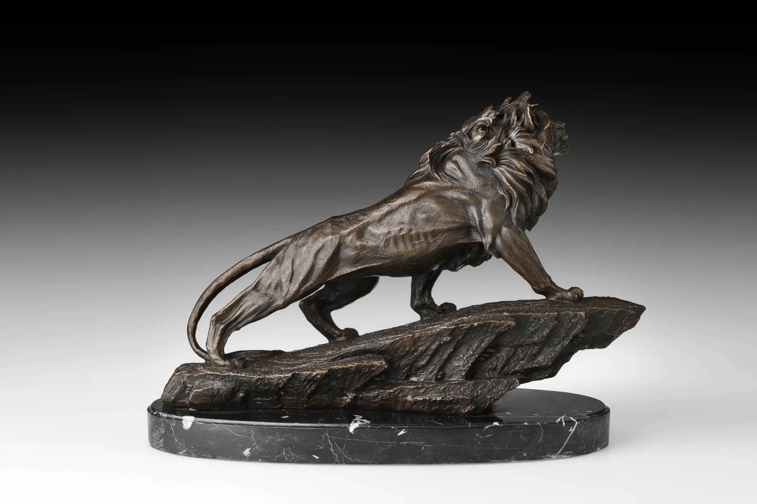 Right side view of striding bronze lion statue with raised head and dark hand-applied patina