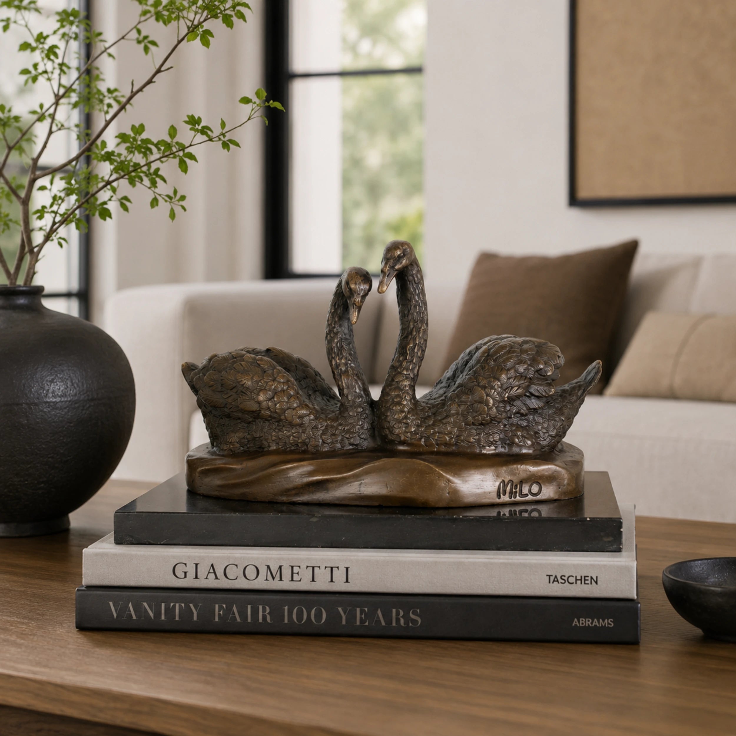 Swan Couple Bronze Sculpture displayed in a styled interior