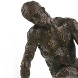 Contemporary bronze sculpture of a crouching male figure covered in chess motifs. A powerful symbol of strategy, control, and the human condition.