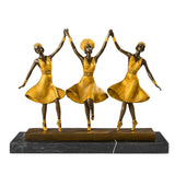Front view of three ballerinas bronze sculpture with joined hands and golden dresses