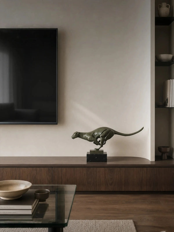 Bronze cheetah sculpture displayed in a customer’s interior space
