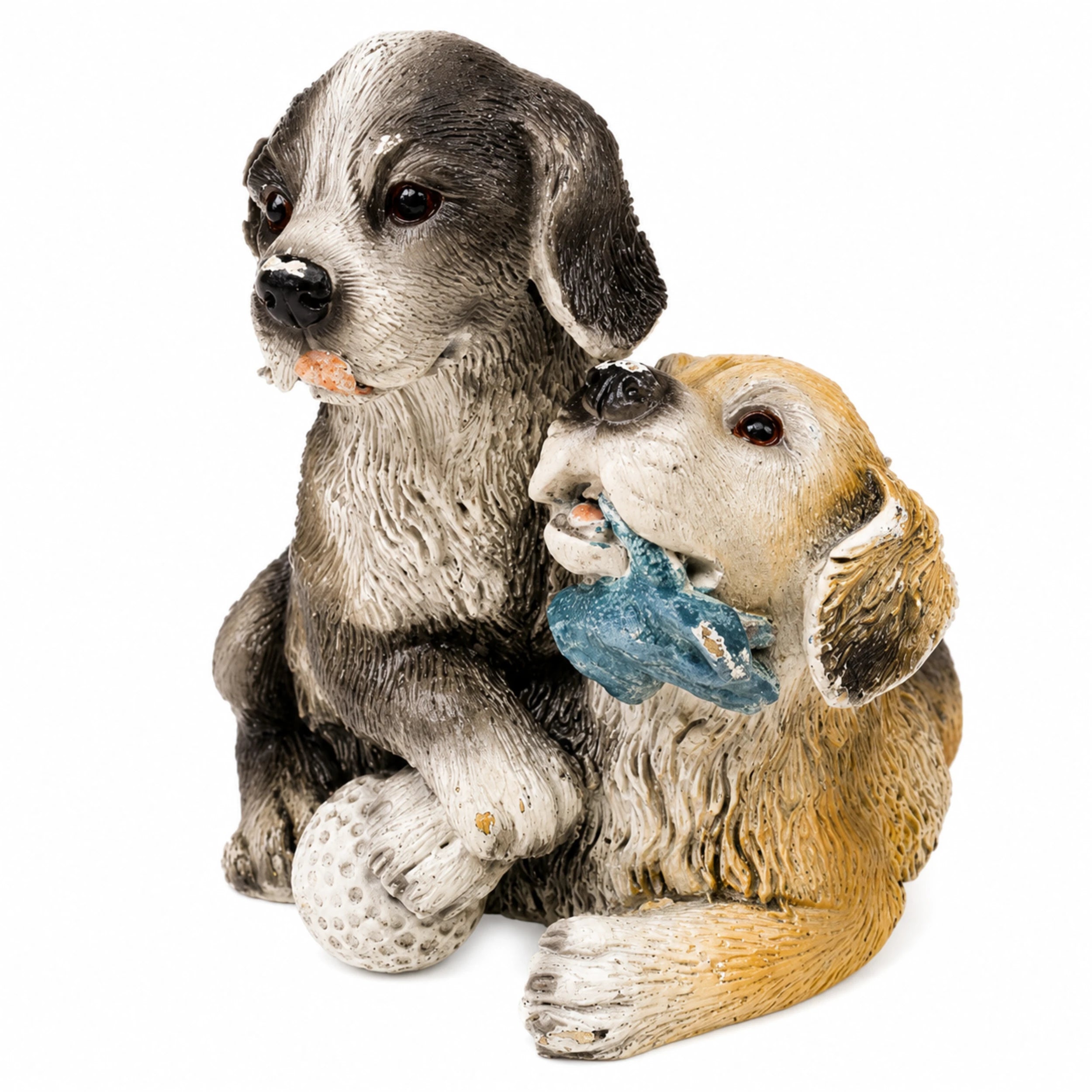 Two playful puppies with toys and a ball in a charming decorative dog pair sculpture