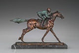 Detail of verdigris green patina on bronze horse racing statue with jockey and saddle accents