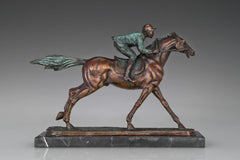 Detail of verdigris green patina on bronze horse racing statue with jockey and saddle accents