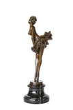 Left side view of vintage ballerina bronze statue showing the sculpted tutu