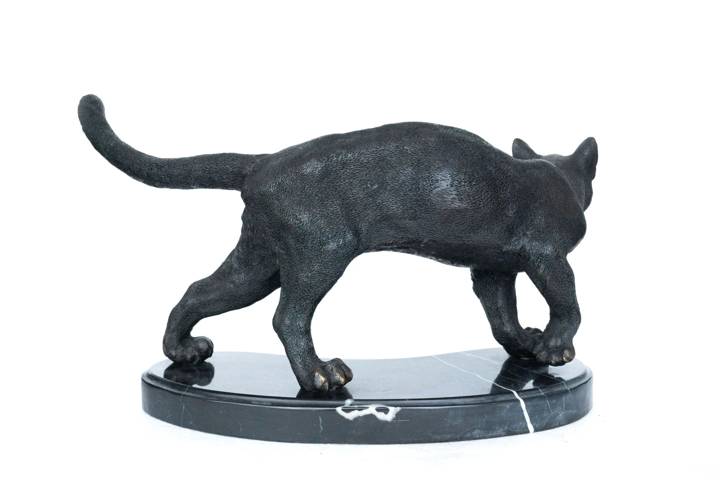 Back view of handcrafted walking cat bronze sculpture with raised tail