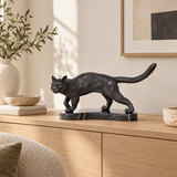Walking Cat bronze statue displayed in a minimalist interior