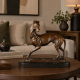 walking greyhound bronze sculpture displayed in a styled interior