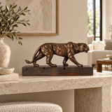 Walking Lioness Bronze Sculpture displayed in a minimalist interior