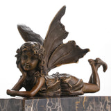 Whimsical bronze reclining fairy statue with butterfly wings on gold-veined marble base, magical fantasy art for bedroom decor.