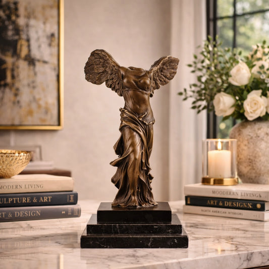 Winged Victory of Samothrace bronze statue with outstretched wings, Greek goddess Nike statue with wind-swept drapery on tiered black marble base, loss wax casting classical art.