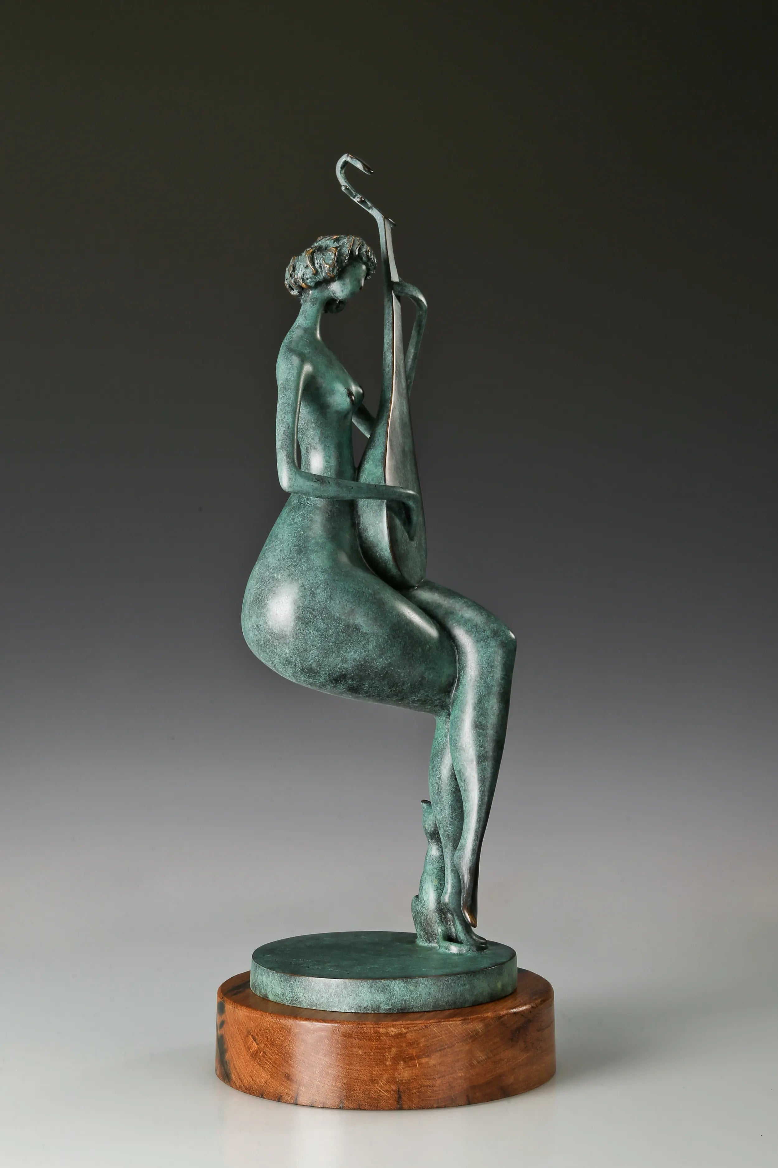 Profile view of a bronze woman holding a traditional Chinese pipa in a seated position